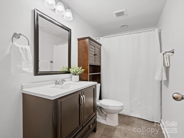 bathroom featuring tile patterned flooring, vanity, and toilet