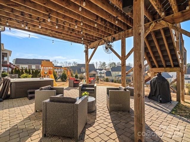 view of patio with a grill, an outdoor hangout area, and a hot tub