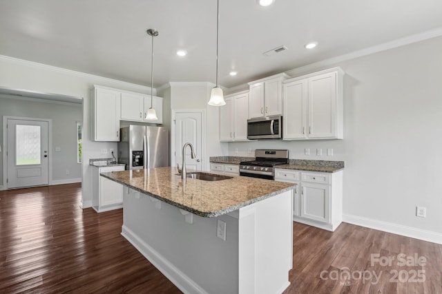 kitchen with white cabinetry, appliances with stainless steel finishes, a kitchen island with sink, and sink