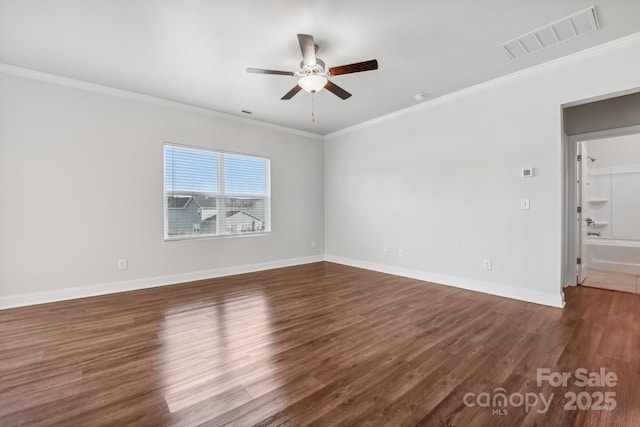 spare room featuring ornamental molding, dark wood-type flooring, and ceiling fan