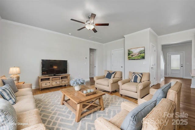 living room with hardwood / wood-style floors, ornamental molding, and ceiling fan