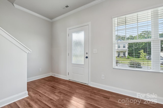 entrance foyer with crown molding, hardwood / wood-style flooring, and plenty of natural light