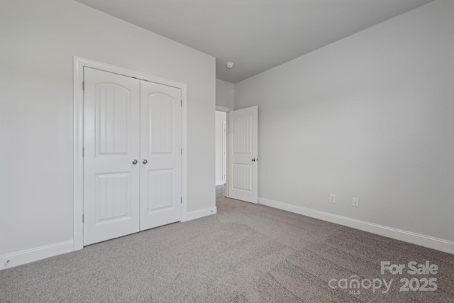 unfurnished bedroom featuring a closet and carpet