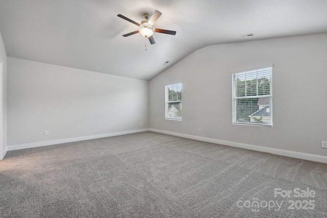 carpeted empty room featuring lofted ceiling and ceiling fan