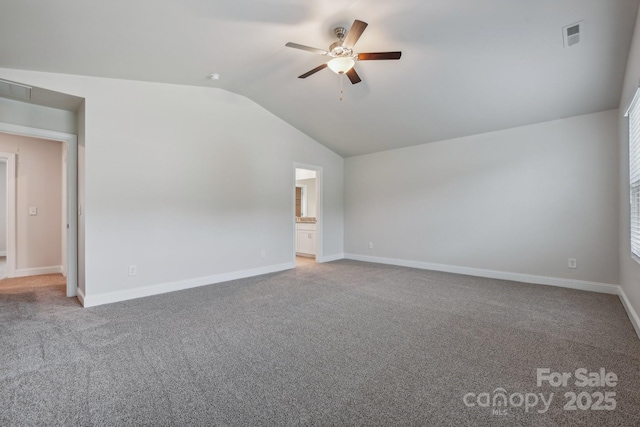 carpeted spare room featuring ceiling fan and lofted ceiling