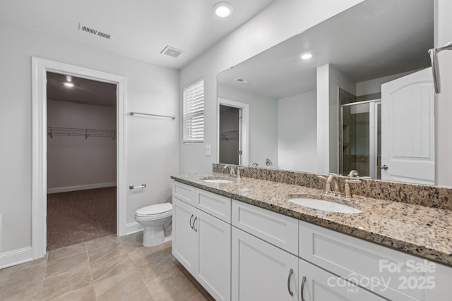 bathroom with vanity, toilet, and walk in shower