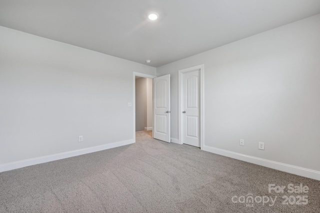 unfurnished room with light carpet