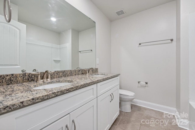 bathroom with tile patterned floors, vanity, and toilet