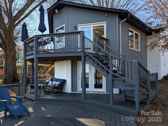 back of property with an outdoor living space and a wooden deck