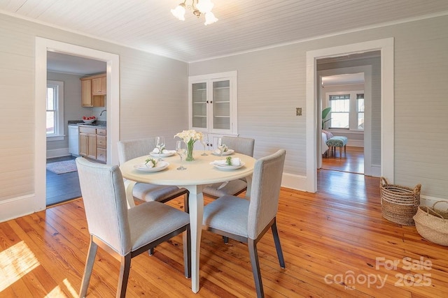 dining room with light wood-style floors, baseboards, and a chandelier