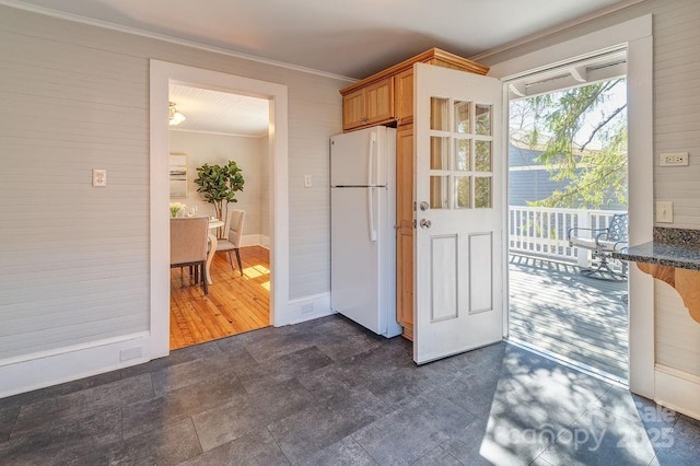 kitchen featuring ornamental molding and freestanding refrigerator