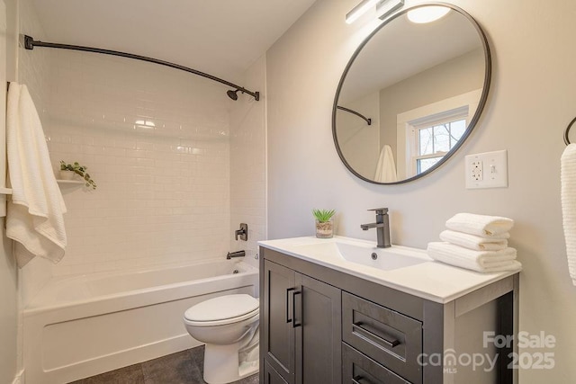 bathroom featuring bathtub / shower combination, vanity, and toilet