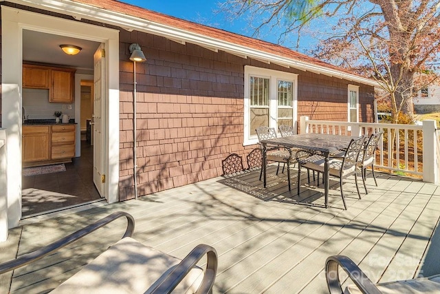 view of patio / terrace with outdoor dining space and a wooden deck