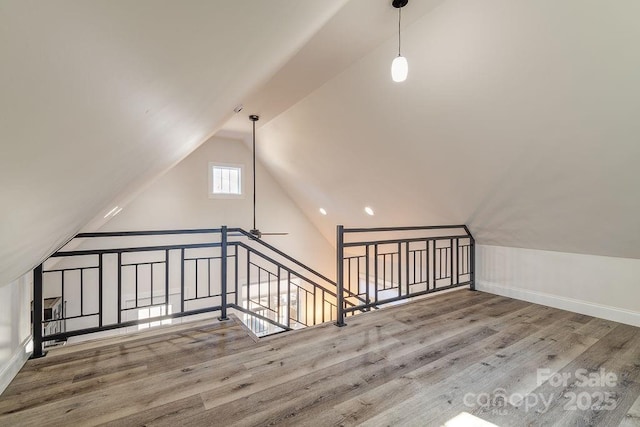 bonus room featuring lofted ceiling and wood finished floors