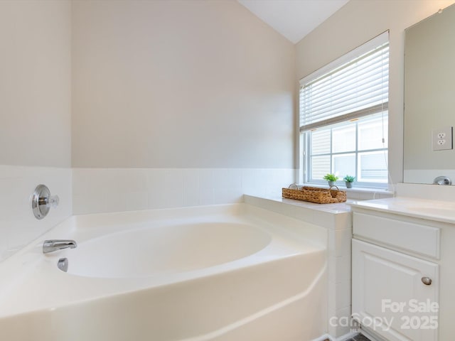 full bath with vanity and a garden tub