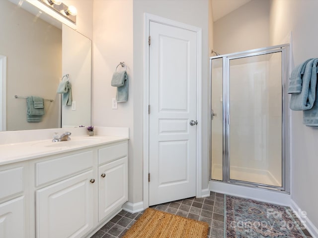 bathroom with vanity, baseboards, a stall shower, tile patterned flooring, and vaulted ceiling