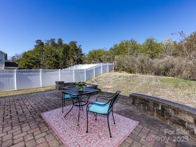 view of patio featuring outdoor dining area and a fenced backyard