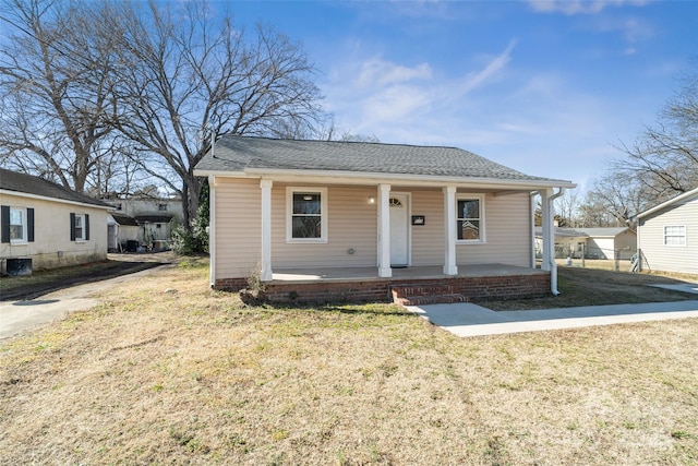 bungalow featuring a porch and a front lawn