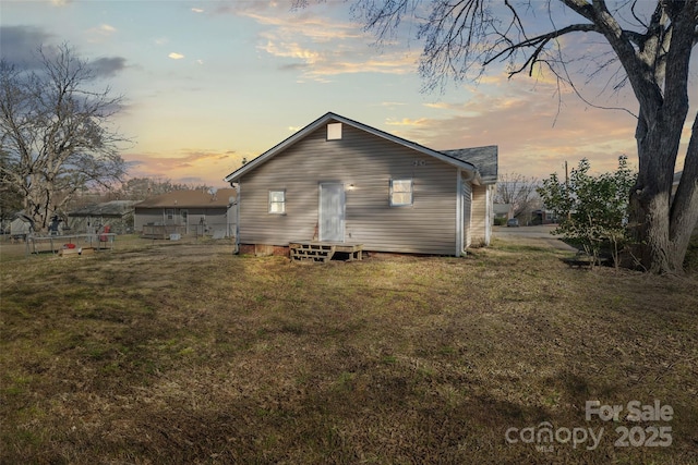 505 Kings Mountain St, Clover, SC 29710 - back house at dusk featuring a lawn