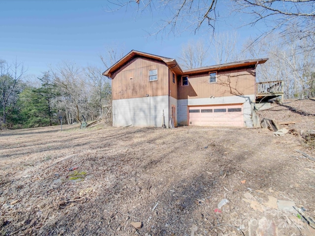 view of side of property with a garage