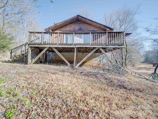 view of property exterior with a wooden deck