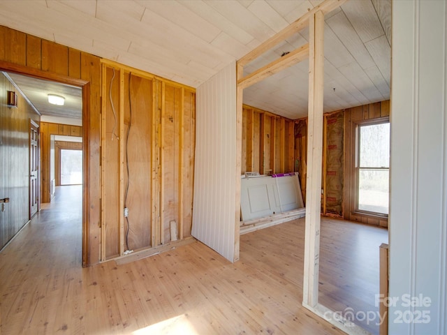 interior space with wooden walls and light hardwood / wood-style floors