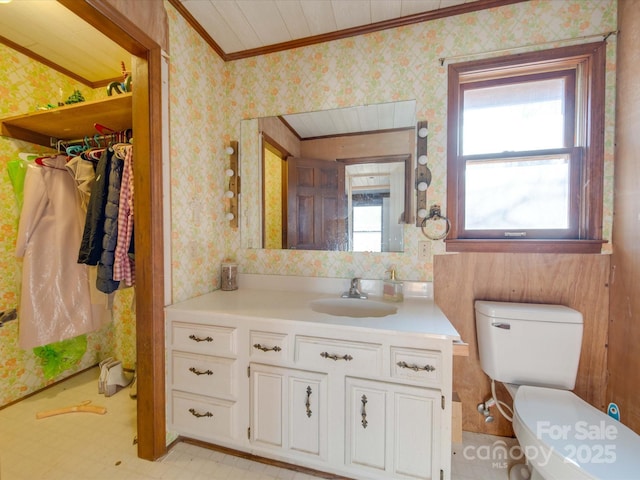 bathroom with vanity, crown molding, and toilet