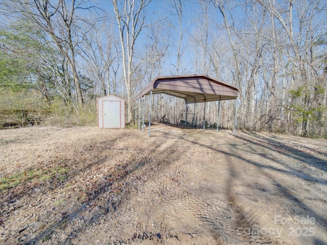 view of yard with a carport and a storage shed