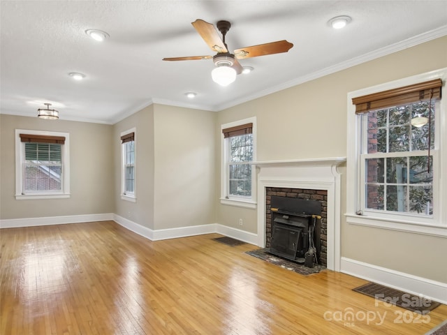 unfurnished living room featuring hardwood / wood-style floors, crown molding, and ceiling fan