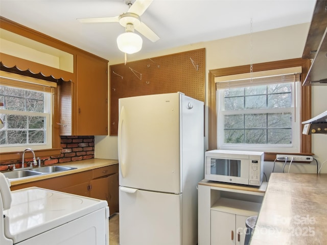 kitchen with ceiling fan, white appliances, and sink