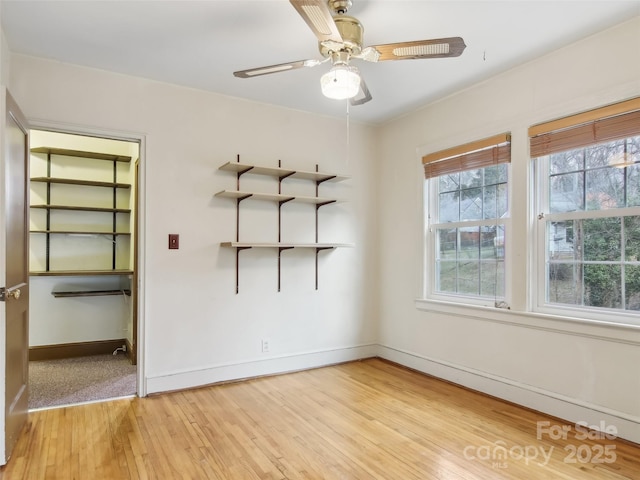 empty room featuring ceiling fan and light wood-type flooring