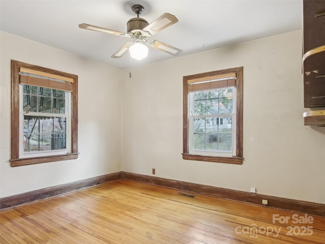 unfurnished room featuring hardwood / wood-style floors and ceiling fan