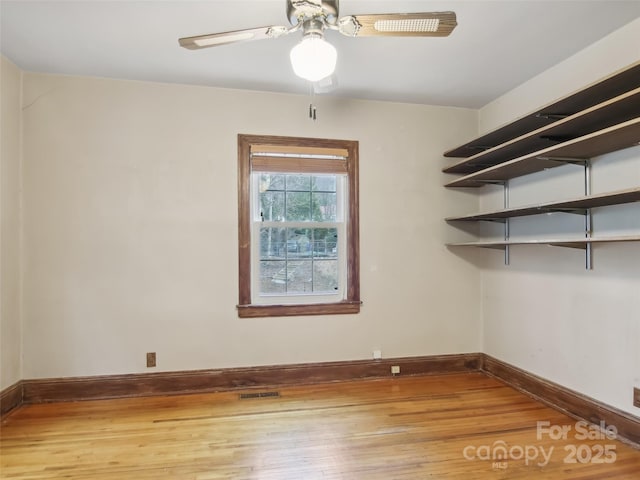 unfurnished room featuring ceiling fan and wood-type flooring