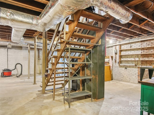 basement featuring brick wall