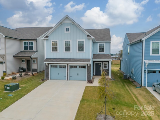 view of front of property with central AC unit, a garage, and a front yard