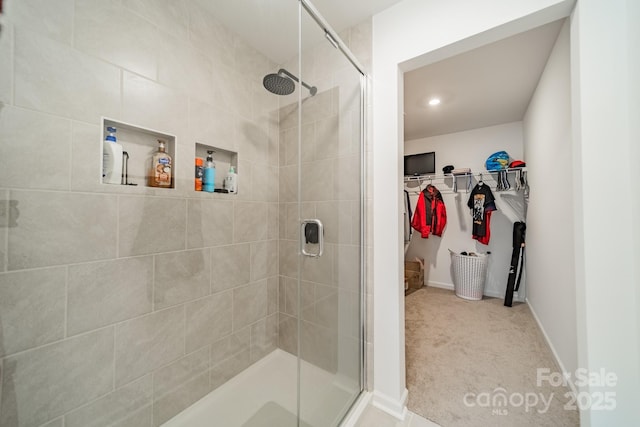 bathroom with a shower with door