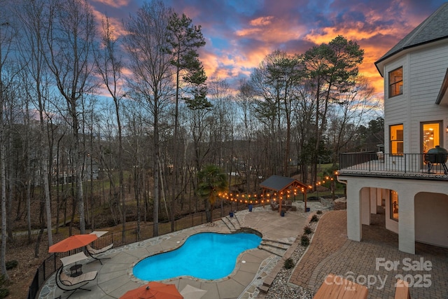 view of swimming pool with a patio, fence, and a fenced in pool