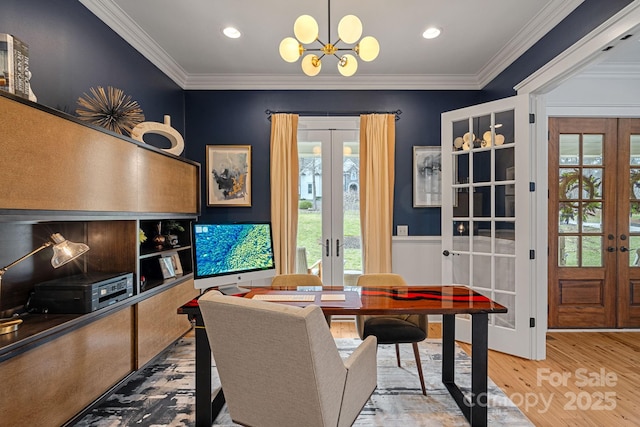 dining area with french doors, recessed lighting, an inviting chandelier, ornamental molding, and wood finished floors