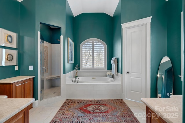 full bath featuring a stall shower, tile patterned flooring, a bath, and vanity