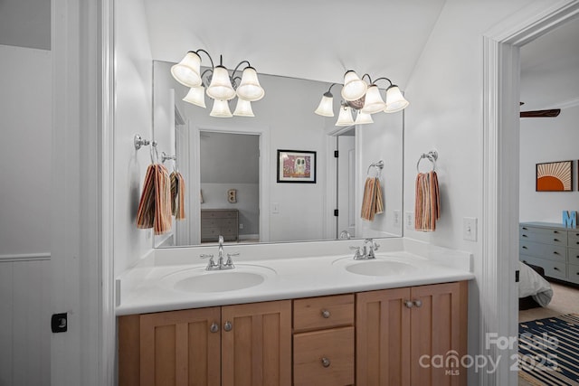 ensuite bathroom featuring ensuite bathroom, double vanity, and a sink