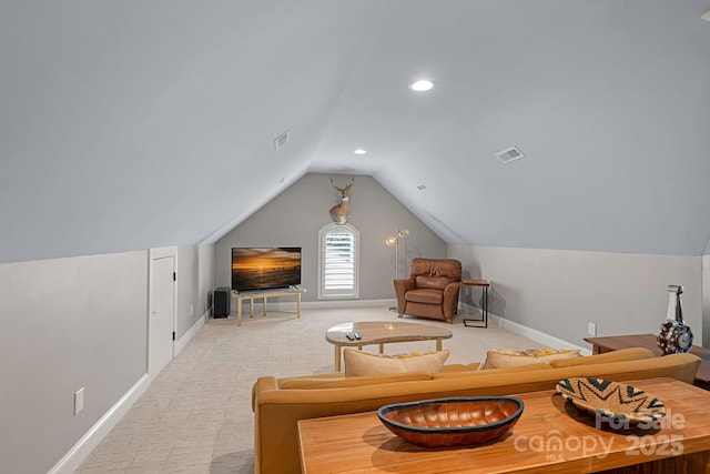 interior space with baseboards, visible vents, vaulted ceiling, and light colored carpet