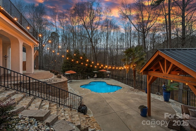 view of swimming pool with a patio, a gazebo, fence, and a fenced in pool