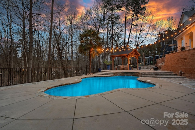 view of swimming pool featuring a fenced in pool, a patio area, fence, and a gazebo