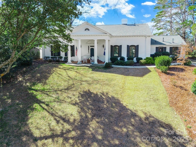 greek revival house with a porch and a front lawn