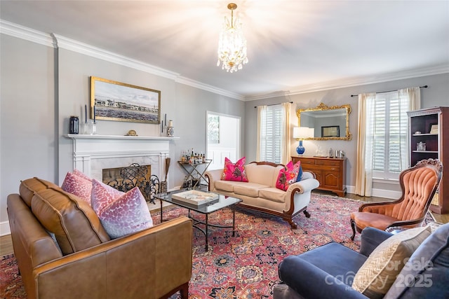 living room featuring a tiled fireplace, a notable chandelier, crown molding, and hardwood / wood-style flooring