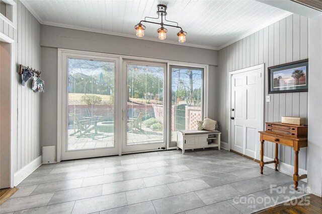 doorway with crown molding and a healthy amount of sunlight