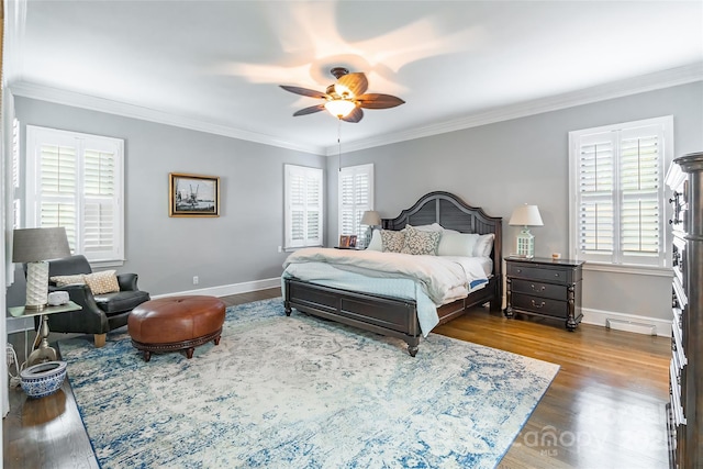 bedroom with dark hardwood / wood-style flooring, ornamental molding, and ceiling fan