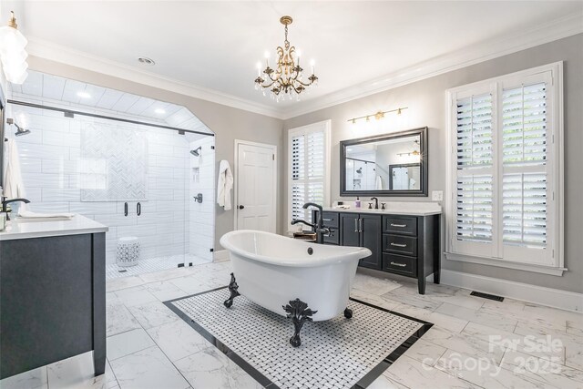 bathroom featuring vanity, a notable chandelier, ornamental molding, and shower with separate bathtub