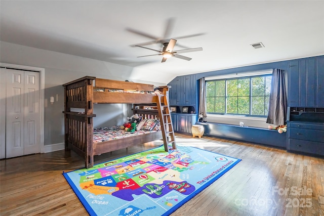 bedroom with wood-type flooring, vaulted ceiling, and ceiling fan