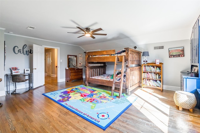 bedroom featuring hardwood / wood-style flooring, ceiling fan, and crown molding